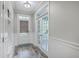 Bright foyer with wood-look flooring, glass panel door to office and door to the exterior at 359 Whispering Breeze Ln, Summerville, SC 29486