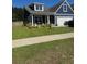 Charming home with a well-manicured lawn and inviting front porch at 359 Whispering Breeze Ln, Summerville, SC 29486