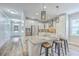 Stylish kitchen island featuring granite countertops, seating, and stainless steel sink at 359 Whispering Breeze Ln, Summerville, SC 29486