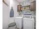 Efficient laundry room with front loading washer/dryer and open shelves for ample storage at 359 Whispering Breeze Ln, Summerville, SC 29486