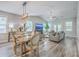 Bright, open-concept living room with dining area, featuring hardwood floors and stylish furniture at 359 Whispering Breeze Ln, Summerville, SC 29486