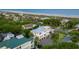 Stunning aerial view showcasing a white beach house with palm trees, ocean, and neighboring colorful homes at 4001 Palm Blvd, Isle of Palms, SC 29451