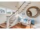 Entryway area with hardwood floors, a staircase, bench with pillows, and round mirror at 4001 Palm Blvd, Isle of Palms, SC 29451