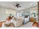 Luxurious main bedroom featuring a four-poster bed, seating area, and abundant natural light at 4001 Palm Blvd, Isle of Palms, SC 29451