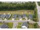 Aerial view of houses with backyard pond access in a wooded suburban neighborhood at 404 Omaha Dr, Moncks Corner, SC 29461