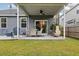 Inviting outdoor space featuring a covered patio, comfortable seating, a chiminea, and a lush green lawn at 404 Omaha Dr, Moncks Corner, SC 29461