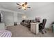 Inviting bedroom with neutral walls, featuring a couch, desk, ceiling fan, and carpeted floor at 404 Omaha Dr, Moncks Corner, SC 29461