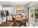 Dining area featuring an elegant light fixture, seating for four, and sliding door access to the outside at 404 Omaha Dr, Moncks Corner, SC 29461