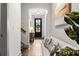 A welcoming entryway features a front door with glass, and a decorative bench and wall decor at 404 Omaha Dr, Moncks Corner, SC 29461