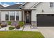 Charming single-Gathering home featuring stone accents, gray vinyl siding, and a welcoming front porch at 404 Omaha Dr, Moncks Corner, SC 29461