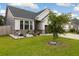 Stylish single-Gathering home featuring stone accents, gray vinyl siding, and a well-maintained front yard at 404 Omaha Dr, Moncks Corner, SC 29461