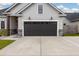 Close up of the garage of a single-Gathering home featuring a dark garage door and stone accents at 404 Omaha Dr, Moncks Corner, SC 29461