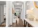 Bright hallway with hardwood floors, leading to a living area and bedroom at 404 Omaha Dr, Moncks Corner, SC 29461
