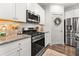 White kitchen featuring stainless steel appliances, granite countertops, and ample counter space at 404 Omaha Dr, Moncks Corner, SC 29461