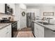 Modern kitchen features granite countertops, stainless steel appliances, and ample cabinet space at 404 Omaha Dr, Moncks Corner, SC 29461