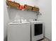 Bright laundry room equipped with a modern washer and dryer, and overhead storage baskets at 404 Omaha Dr, Moncks Corner, SC 29461