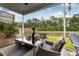 Cozy covered patio with a glass-topped table, wicker chairs, and a view of the fenced backyard at 404 Omaha Dr, Moncks Corner, SC 29461