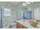 Charming bathroom featuring floral wallpaper, ample counter space, and a large mirror at 416 Prestwick Ct, Summerville, SC 29483
