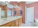 Bathroom features a double sink vanity, large mirror, red striped wallpaper and white tile floor at 416 Prestwick Ct, Summerville, SC 29483