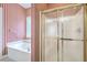 Bathroom features a glass enclosed shower, and a separate soaking tub under a glass block window at 416 Prestwick Ct, Summerville, SC 29483