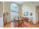 Bright dining room with a large window, hardwood floors, chandelier, and traditional-style wooden furniture at 416 Prestwick Ct, Summerville, SC 29483
