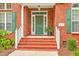 Welcoming front entrance with a green door, decorative wreath, and classic brick steps and facade at 416 Prestwick Ct, Summerville, SC 29483