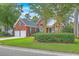 Traditional brick home with a two-car garage, complemented by green shutters and mature trees at 416 Prestwick Ct, Summerville, SC 29483