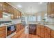 Spacious kitchen offering wooden cabinets, tiled backsplash, updated appliances, and eat-in breakfast area at 416 Prestwick Ct, Summerville, SC 29483