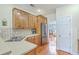 Well-lit kitchen featuring wood cabinetry, stainless steel refrigerator, tile backsplash and wooden floor at 416 Prestwick Ct, Summerville, SC 29483