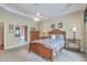This is a spacious bedroom with tray ceiling, ceiling fan and ensuite bathroom at 416 Prestwick Ct, Summerville, SC 29483