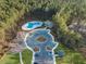 Aerial view of community amenities, including a pool, park, and parking, surrounded by lush greenery at 436 Rowley Ln, Summerville, SC 29486