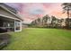 Large, well-maintained backyard with lush green grass and tall pine trees at 436 Rowley Ln, Summerville, SC 29486