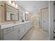 Bathroom showcasing double sink vanities and a glass enclosed walk-in shower with a tiled floor at 436 Rowley Ln, Summerville, SC 29486