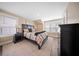 Inviting bedroom with natural light, complemented by dark furniture and a patterned comforter on a decorative rug at 436 Rowley Ln, Summerville, SC 29486
