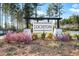 Elegant entrance sign for Lochton community, framed by vibrant landscaping and towering pine trees at 436 Rowley Ln, Summerville, SC 29486