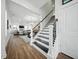 Bright foyer with hardwood floors, staircase with decorative white and black risers, and an open floor plan at 436 Rowley Ln, Summerville, SC 29486
