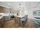Modern kitchen with stainless steel appliances, large island with seating, and elegant pendant lighting at 436 Rowley Ln, Summerville, SC 29486