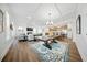 Open-concept living space featuring hardwood floors, coffered ceilings, and seamless flow to the kitchen at 436 Rowley Ln, Summerville, SC 29486