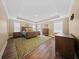 Spacious main bedroom featuring tray ceilings, multiple windows, wood floors, and a decorative rug at 436 Rowley Ln, Summerville, SC 29486
