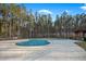 Community pool surrounded by a paved deck and tall trees, ideal for relaxation and recreation at 436 Rowley Ln, Summerville, SC 29486