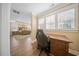 Comfortable work space with wood floors and bright natural light, with a partial view to the main bedroom at 436 Rowley Ln, Summerville, SC 29486