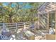 Relax on this serene deck with cozy furniture and shaded by mature trees at 4403 Sea Forest Dr, Kiawah Island, SC 29455