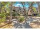 Multi-story house exterior with wood shingles, trees, bushes and surrounding green spaces at 4403 Sea Forest Dr, Kiawah Island, SC 29455