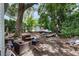 Sprawling backyard featuring mature trees, shed, lounge seating, and trailer with jet skis at 4406 Holmes Ave, North Charleston, SC 29405