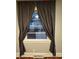 Window with natural light and privacy curtains at 4406 Holmes Ave, North Charleston, SC 29405