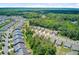 Expansive aerial view of a vibrant community nestled amongst lush greenery and mature trees at 5078 Song Sparrow Way, Summerville, SC 29483