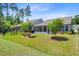 Backyard with manicured lawn, fence and view of screened porch at 5078 Song Sparrow Way, Summerville, SC 29483