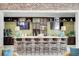 Stylish bar area featuring brick accents, modern appliances, and comfortable seating at 5078 Song Sparrow Way, Summerville, SC 29483