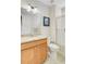 Well-lit bathroom features a vanity with a granite countertop and a shower with a striped curtain at 5078 Song Sparrow Way, Summerville, SC 29483