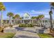 Elegant clubhouse exterior featuring a fountain, lush landscaping, and ample parking at 5078 Song Sparrow Way, Summerville, SC 29483